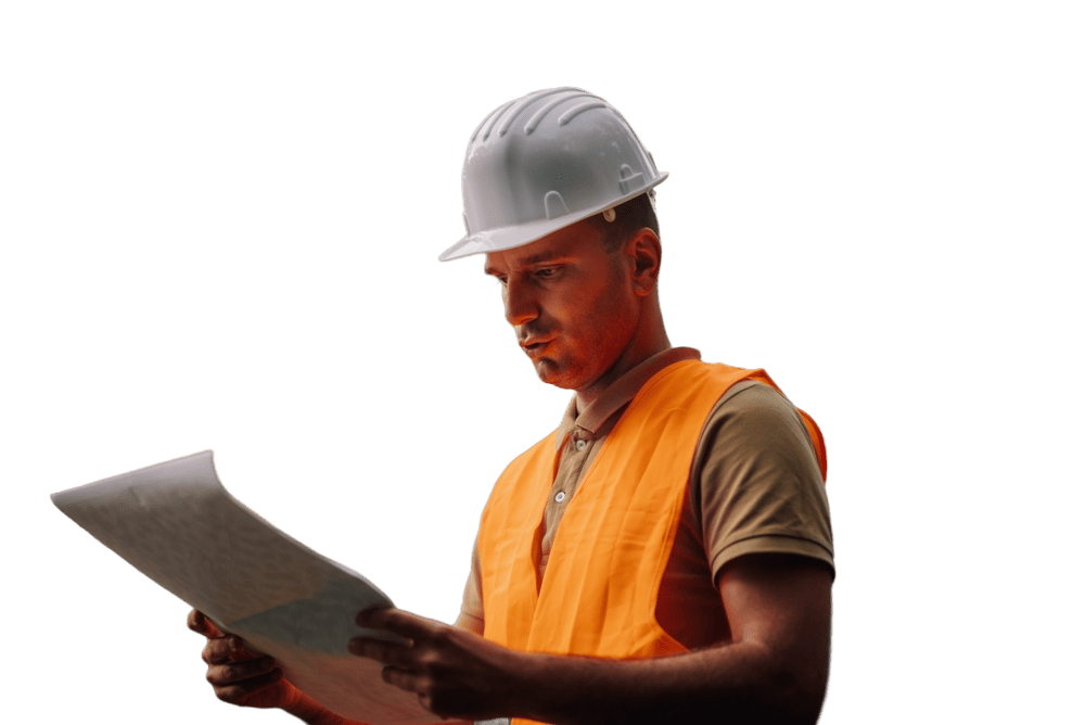 Forestry engineer wearing safety helmet and high-visibility vest examines blueprint in forest, planning sustainable development project.